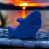 Shark fish bath bomb blue on a towel at sunset. At calla Lily all natural cocoa butter coconut oil non toxic kid friendly