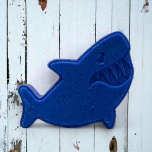Shark fish bath bomb blue on a wooded background. At calla Lily all natural cocoa butter coconut oil non toxic kid friendly